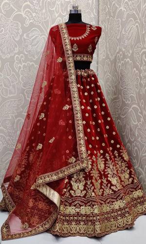 Every Womens Favourite Color In Lehenga Is Here In Maroon Color. This Heavy designer Maroon Colored lehenga Choli IS Velvet Based Paired With Net Fabricated Dupatta. Its royal Color And Embroidery Will Earn You Lots Of Compliments From Onlookers. 