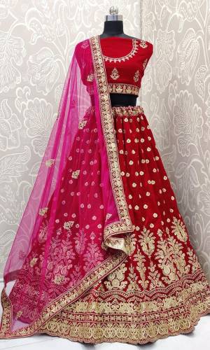 Every Womens Favourite Color In Lehenga Is Here In Maroon Color. This Heavy designer Dark Pink Colored lehenga Choli IS Velvet Based Paired With Net Fabricated Dupatta. Its royal Color And Embroidery Will Earn You Lots Of Compliments From Onlookers. 
