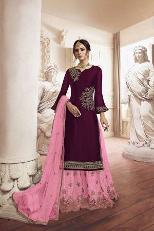 Grab This Very Beautiful Designer Sharara Suit In Wine Colored Top Paired With Pink Colored Bottom And Dupatta. Its Top Is Fabricated On Georgette Paired With Net Fabricated Bottom and Dupatta. It Has Detailed Pretty Embroidery Giving An Attractive Look. 