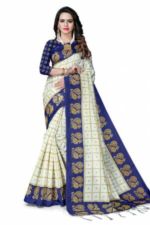 Celebrate This Festive Season With Beauty And Comfort Wearing This Designer Silk Based Saree In White And Blue Color Paired With Blue Colored Blouse. This Pretty Saree And Blouse Are Fabricated On Art Silk Beautified With Heavy Weaved Lace Border. Buy Now.