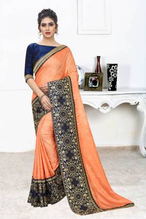 Celebrate This Festive Season With This Designer Elegant Saree In Orange Color Paired With Contrasting Royal Blue Colored Blouse. This Saree Is Fabricated On Jacquard Silk Paired With Art Silk Fabricated Blouse. Its Broad Border Is Beautified With Heavy Jari & Stone Work. 