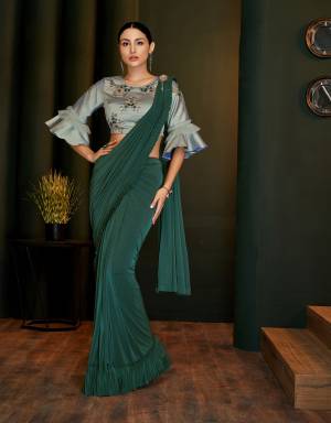 Show off your upscale inclinations in this gorgeous green pre-pleated saree adorned with handwork blouse and look mesmerizing