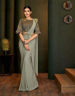 Glorify yourself as a diva in this sophisticated saree adorned with a handwork blouse and a belt. Combine with simple jewels this look will make you look outstanding. 