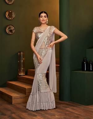 Trendy and contemporary , this pre-pleated saree is a must-have if you love to experiment with your fashion choices. Adorn it with classic diamond jewels for a sophisticated appeal. 