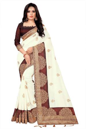 You Will Definitely Earn Lots Of Compliments Wearing This Rich And Elegant Looking Designer Saree In Off-White Color Paired With Brown Colored Blouse. This Saree Fabricated On Vichitra Silk Paired With Tafeta Art Silk Blouse. Buy This Pretty Saree Now.
