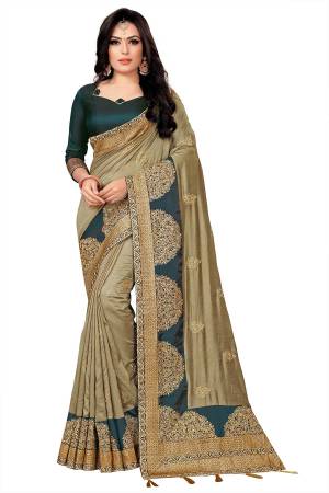 You Will Definitely Earn Lots Of Compliments Wearing This Rich And Elegant Looking Designer Saree In Beige Color Paired With Teal Blue Colored Blouse. This Saree Fabricated On Vichitra Silk Paired With Tafeta Art Silk Blouse. Buy This Pretty Saree Now.