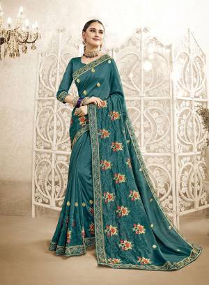 You Will Definitely Earn Lots Of Compliments Wearing This Designer Saree In Teal Blue Color. This Saree And Blouse Are Silk Based Beautified With Attractive Embroidery. Buy This Pretty Piece Now.