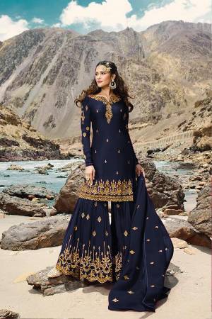 Grab This Very Pretty All Over Designer Sharara Suit In Navy Blue Color. Its Lovely Top, Bottom And Dupatta Are Fabricated On Georgette Beautified With Jari Embroidery And Stone Work. Buy Now.