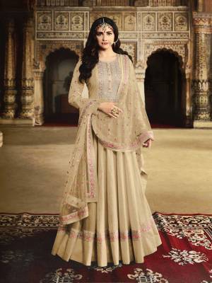 Get Ready For The Upcoming Wedding And Festive Season With This Heavy Designer Floor Length Suit In Beige Color. Its Embroidered Top Is Fabricated On Georgette Paired With Santoon Bottom And Net Fabricated Embroidered Dupatta. 