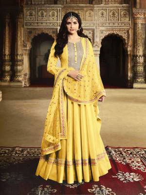 Get Ready For The Upcoming Wedding And Festive Season With This Heavy Designer Floor Length Suit In Yellow Color. Its Embroidered Top Is Fabricated On Georgette Paired With Santoon Bottom And Net Fabricated Embroidered Dupatta. 