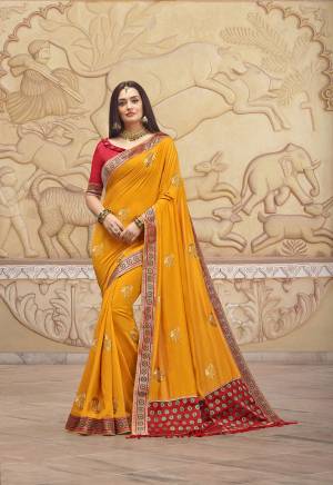 Celebrate This Festive With This Lovely Designer Saree In Musturd Yellow Color Paired With Contrasting Red Colored Blouse. This Saree And Blouse Are Silk Beautified With Attractive Weaved Border And Embroidered Motifs. 
