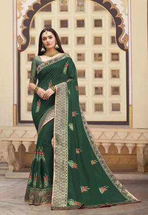 Add This Pretty Piece To Your Wardrobe With This Designer Saree In Dark Green Color. This Saree And blouse Are Silk Based Beautified With Embroidered Motifs And Weave Lace Border.