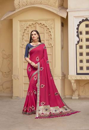 Celebrate This Festive With This Lovely Designer Saree In Dark Pink Color Paired With Contrasting Navy Blue Colored Blouse. This Saree And Blouse Are Silk Beautified With Attractive Weaved Border And Embroidered Motifs. 