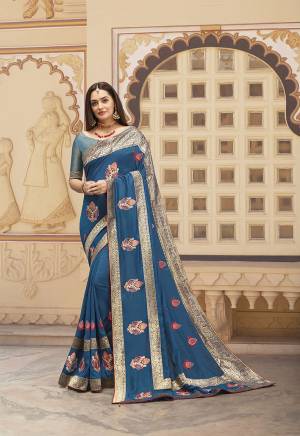 Add This Pretty Piece To Your Wardrobe With This Designer Saree In Blue Color. This Saree And blouse Are Silk Based Beautified With Embroidered Motifs And Weave Lace Border.