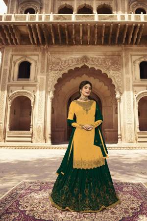 Grab This Very Beautiful Two In One Designer Lehenga Suit Which Comes With Two Bottoms. This Pretty Suit Is In Yellow Colored Top And Bottom Paired With Green Colored Lehenga And Dupatta. Its Embroidered Top, Lehenga And Dupatta Are Fabricated On Georgette Paired With Santoon Fabricated Bottom. Buy Now.