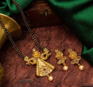 Grab This Heavy Double Chained Traditional Patterned Magalsutra Set Which Has A Heavy Designer Attatched Pendant With A Pair Of Earrings. This Mangalsutra Can Be Paired With Any Colored Traditional Attire And Suitable For Occasion Wear. Buy Now