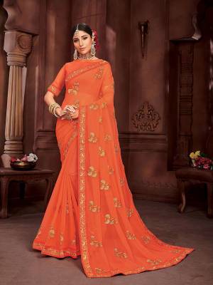 Here Is Pretty Simple And Elegant Looking Designer Saree In Orange Color. This Pretty Embroidered Saree Is Chiffon Based Which Is Light In Weight And Easy To Carry Throughout The Gala.