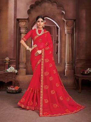 Add This Beautiful Saree To your Wardrobe In Red Color. This Pretty Saree Is Chiffon Based Beautified With Embrioidered Motifs. It Is Light In Weight And Easy To Carry All Day Long. 