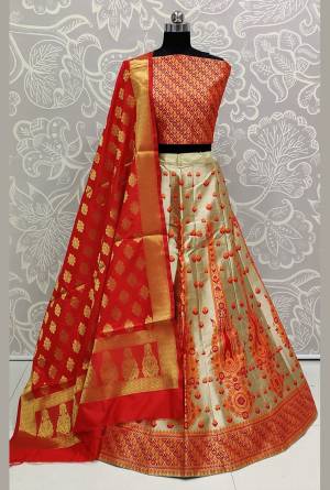 Here Is Rich Silk Based Designer Lehenga Choli In Red, Orange And Cream Color. Its Pretty Blouse And Lehenga Are Silk Based Paired With Banarasi Silk Weaved Dupatta. Buy This Semi-Stitched Lehenga Choli Now.