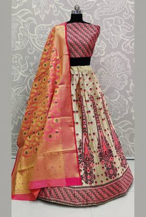 Here Is Rich Silk Based Designer Lehenga Choli In Pink And Cream Color. Its Pretty Blouse And Lehenga Are Silk Based Paired With Banarasi Silk Weaved Dupatta. Buy This Semi-Stitched Lehenga Choli Now.