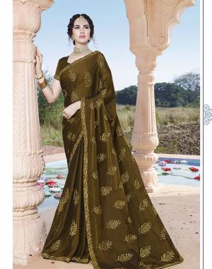 Enhance Your Personality Wearing This Designer Saree In Dark Olive Green Color. This Pretty Tone To Tone Embroidered Saree Is Fabricated On Chinon Paired With Art Silk Fabricated Blouse. Also It Is Light Weight And easy To Drape. 