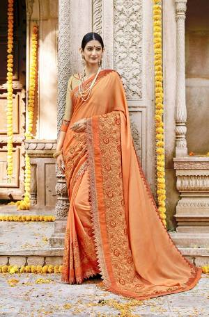 Shine Bright In This Designer Orange Colored Saree Paired With Golden Colored Blouse. This Saree Is Fabricated on Silk Georgette Paired With Art Silk Fabricated Blouse. It Is Beautified With Deatiled Embroidery Giving An Attractive Look. 