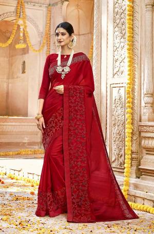 Adorn The Pretty Angelic Look In This Beautiful Red Colored Saree. This Saree Is Fabricated On Silk Georgette Paired With Art Silk Blouse. It Is Beautified With Tone To Tone Embroidery giving A Subtle Look. 