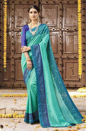 Shine Bright In This Designer Sea Green Colored Saree Paired With Blue Colored Blouse. This Saree Is Fabricated on Silk Georgette Paired With Art Silk Fabricated Blouse. It Is Beautified With Deatiled Embroidery Giving An Attractive Look. 