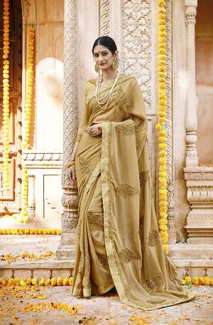 Flaunt Your Rich And Elegant Taste Wearing This Designer Saree In Elegant Beige Color. This Pretty Tone To Tone Embroidered Saree Is Silk Georgette Based Paired With Art Silk Blouse. 