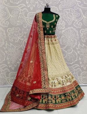 Here Is A Heavy Designer Lehenga Choli In A Proper Traditional Look With Traditional Color Combination In Dark Green Colored Blouse Paired With Rich Cream Colored Heavy Embroidered Lehenga And Contrasting Red Colored Dupatta. This Pretty Blouse And Lehenga Are Satin Based Paired With Net Fabricated Dupatta. 