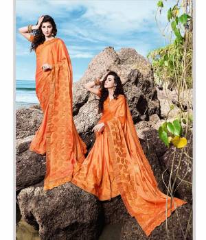 Shine Bright In This Designer Orange Colored Saree Paired With Orange Colored Blouse. This Saree Is Satin Georgette Based Paired With Art Silk Fabricated Blouse. It Is Beautified With Tone To Tone Embroidery Work