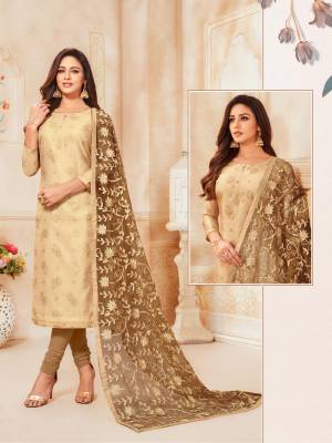 Flaunt Your Rich Taste Wearing This Heavy Dupatta Embroidered Suit In Beige Colored Top Paired With Light Brown Colored Bottom And Dupatta. Its Top Is Fabricated On Modal Silk Paired With Cotton Bottom And Net Fabricated Dupatta. Buy This Pretty Suit Now.