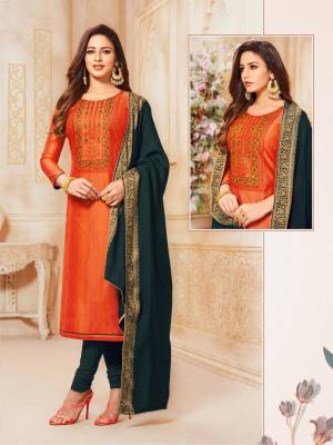 For Your Semi-Casual Wear, Grab This Lovely Straight Suit In Orange Color Paired With Dark Grey Colored Bottom And Dupatta. Its Top Is Fabricated On South Cotton Paired With Cotton Bottom And Jacquard Silk Fabricated Dupatta. Buy Now.
