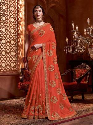 Get Ready For The Upcoming Wedding And Festive Season With This Designer Saree In Orange Color. This Tone To Tone Embroidered Saree Is Fabricated On Vichitra Silk Paired With Art Silk Fabricated Blouse.
