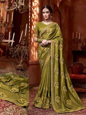 Get Ready For The Upcoming Wedding And Festive Season With This Designer Saree In Olive Green Color. This Tone To Tone Embroidered Saree Is Fabricated On Vichitra Silk Paired With Art Silk Fabricated Blouse.