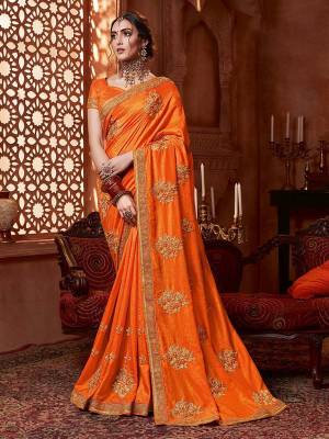 Get Ready For The Upcoming Wedding And Festive Season With This Designer Saree In Orange Color. This Tone To Tone Embroidered Saree Is Fabricated On Vichitra Silk Paired With Art Silk Fabricated Blouse.