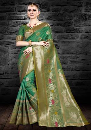 Grab This Beautiful Silk Based Saree In Green Color Paired With Green Colored Blouse. This Saree And Blouse Are Fabricated On Art Silk Beautified With Weave All Over It. 