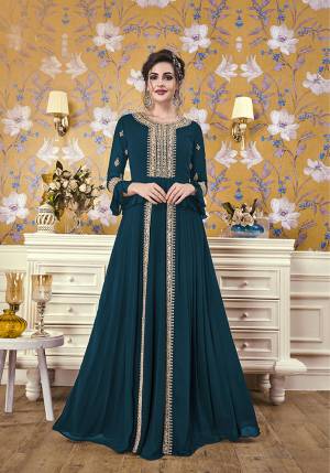 Here Is A New And Unique Patterned Designer Readymade Gown In Teal Blue Color. This Pretty Gown Is Fabricated On Georgette Beautiufied With Attractive Detailed Embroidery. You Will Definitely Earn Lots Of Compliments In This Lovely Puplum Patterned Designer Gown. 