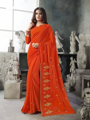 For Your Semi-Casual Wear, Grab This Pretty Saree In Orange Color. This Saree And Blouse Are Georgette Based With A Minimal Of Embroidery Work With Jari And Tone To Tone Resham. 