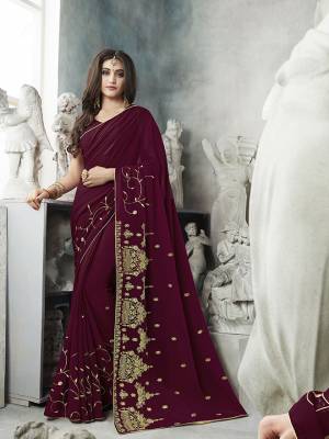 For Your Semi-Casual Wear, Grab This Pretty Saree In Wine Color. This Saree And Blouse Are Georgette Based With A Minimal Of Embroidery Work With Jari And Tone To Tone Resham. 