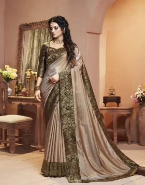 Grab This Pretty Attractive Saree In Beige Color Paired With Brown Colored Blouse. This Saree Is Fabricated On Satin Silk Paired With Brocade Fabricated Blouse. Its Rich Fabric And Color Will Earn You Lots Of Compliments From Onlookers.