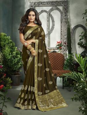 Flaunt Your Rich And Elegant Taste In This Pretty Olive Green Colored Saree. This Saree And Blouse Are Fabricated On Art Silk Beautified With Broad Weaved Lace Border And Jari Embroidered Motifs. 