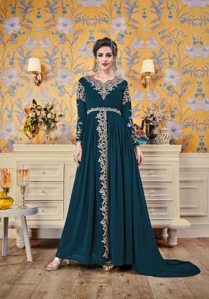 Here Is A New And Unique Patterned Designer Readymade Gown In Teal Blue Color. This Pretty Gown Is Fabricated On Georgette Beautiufied With Attractive Detailed Embroidery. You Will Definitely Earn Lots Of Compliments In This Lovely Patterned Designer Gown.