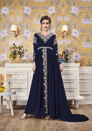Here Is A New And Unique Patterned Designer Readymade Gown In Navy Blue Color. This Pretty Gown Is Fabricated On Georgette Beautiufied With Attractive Detailed Embroidery. You Will Definitely Earn Lots Of Compliments In This Lovely Patterned Designer Gown.