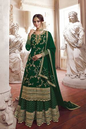 Here Is A Beautiful Designer Sharara Suit In Dark Green Color Fabricated On Georgette. It Is Beautified With Jari Embroidery Highlighted With Sequence & Stone Work. 