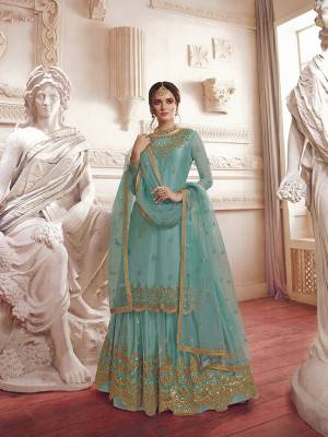 Add This Lovely Suit To Your Wardrobe In All Over Sky Blue Color. This Pretty Heavy Embroidered Suit Is Net Based Beautified With Attractive Embroidery. 