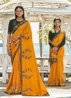 Celebrate This Festive Season Wearing This Designner Saree In Musturd Yellow Color Paired With Contrasting Dark Olive Green Colored Blouse. This Saree And Blouse Are Silk Based Beautified With Detailed Embroidery. Buy Now.