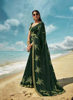 Grab This Beautiful Designer Saree For The Upcoming Festive And Wedding Season In Pine Green Color. This Saree And Blouse Are Silk based Which Gives A Rich Look To Your Personality. 