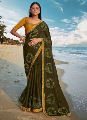 Grab This Beautiful Designer Saree For The Upcoming Festive And Wedding Season In Dark Olive Green Paired With Contrasting Musturd Yellow Colored Blouse. This Saree And Blouse Are Silk based Which Gives A Rich Look To Your Personality. 