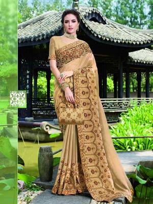 Opt for This Rich and elegant Looking Heavy Designer Saree In Beige Color. Also It Is Beautified With Tone To Tone Embroidery Which Gives A Real Subtle Look. 
